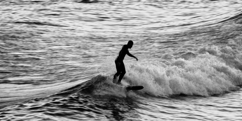 Surfer riding a wave, a classic image of effortless flow-state performance