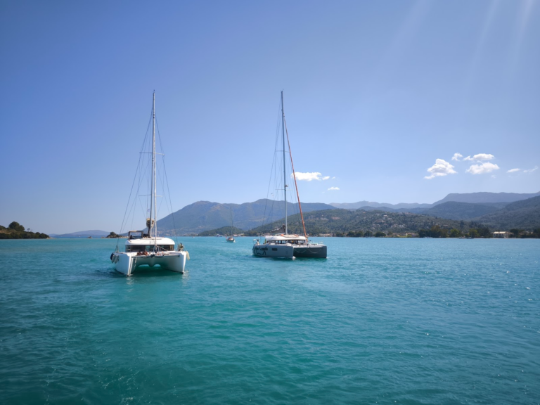 Two catamarans anchored in a turquoise bay off Lefkada, Greece
